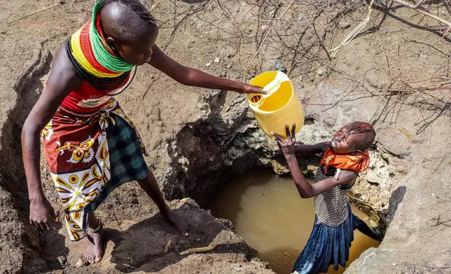 Turkana women fetch water from a well in Lopii Village, Turkana County, Kenya, Monday, Feb. 9, 2026. (AP Photo/Patrick Ngugi)