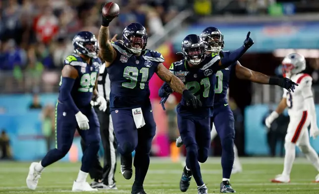 Seattle Seahawks Byron Murphy II (91), Devon Witherspoon (21), and the Seahawks defense celebrate after Murphy recovered a fumble after a sack during the third quarter of Super Bowl 60 in Santa Clara, Calif., Sunday, Feb. 8, 2026. (Scott Strazzante/San Francisco Chronicle via AP)