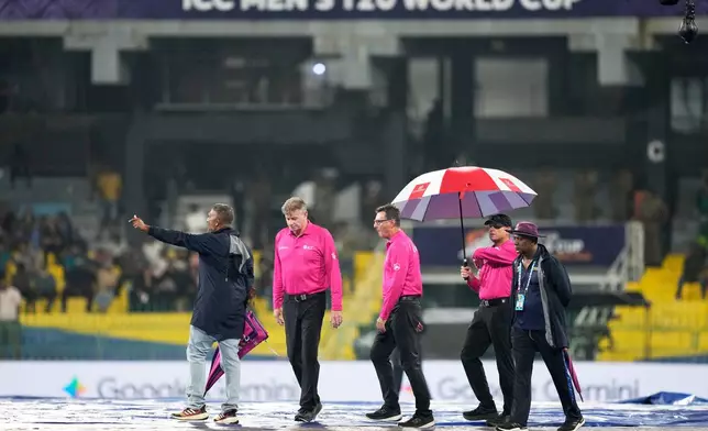 Match umpires inspect the ground before the start of the T20 World Cup cricket match between New Zealand and Pakistan in Colombo, Sri Lanka, Saturday, Feb. 21, 2026. (AP Photo/Eranga Jayawardena)