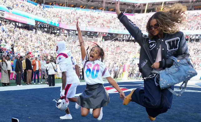 Blue Ivy Carter poses for photos in the end zone before the NFL Super Bowl 60 football game between the New England Patriots and the Seattle Seahawks, Sunday, Feb. 8, 2026, in Santa Clara, Calif. (AP Photo/Julio Cortez)