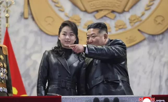 In this photo provided by the North Korean government, its leader Kim Jong Un attends a parade with his daughter in Pyongyang, North Korea Wednesday, Feb. 25, 2026 as the North wrapped up the Workers’ Party congress. Independent journalists were not given access to cover the event depicted in this image distributed by the North Korean government. The content of this image is as provided and cannot be independently verified. Korean language watermark on image as provided by source reads: "KCNA" which is the abbreviation for Korean Central News Agency. (Korean Central News Agency/Korea News Service via AP)