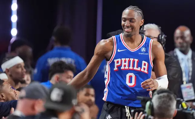 Philadelphia 76ers guard Tyrese Maxey shakes hands with competitors during the 3-point contest at the NBA basketball All-Star weekend festivities Saturday, Feb. 14, 2026, in Inglewood, Calif. (AP Photo/Jae C. Hong)
