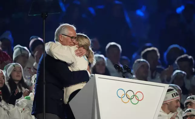 President of the Milan Cortina 2026 foundation Giovanni Malago and IOC President Kirsty Coventry, right, embrace during the closing ceremony of the 2026 Winter Olympics, in Verona, Italy, Sunday, Feb. 22, 2026. (AP Photo/Natacha Pisarenko)