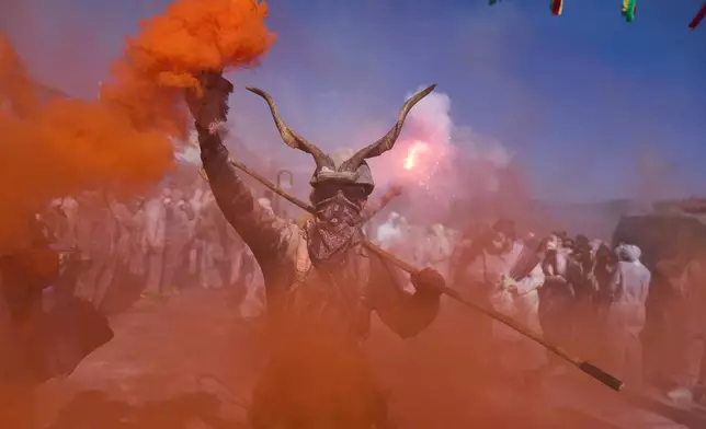 Revelers take part in the annual flour war marking the end of the Carnival season on Clean Monday in Galaxidi, about 200 kilometers (120 miles) west of Athens, Feb. 23, 2026, starting the 40-day Christian Lent fast leading to Easter. (AP Photo/Petros Giannakouris)