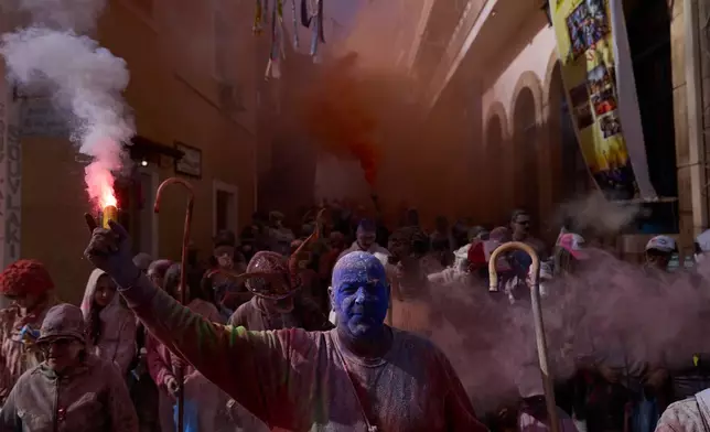 Revelers take part in the annual flour war marking the end of the Carnival season on Clean Monday in Galaxidi, about 200 kilometers (120 miles) west of Athens, Monday Feb. 23, 2026, starting the 40-day Christian Lent fast leading to Easter. (AP Photo/Petros Giannakouris)
