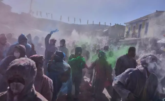 Revelers take part in the annual flour war marking the end of the Carnival season on Clean Monday in Galaxidi, about 200 kilometers (120 miles) west of Athens, Feb. 23, 2026, starting the 40-day Christian Lent fast leading to Easter. (AP Photo/Petros Giannakouris)