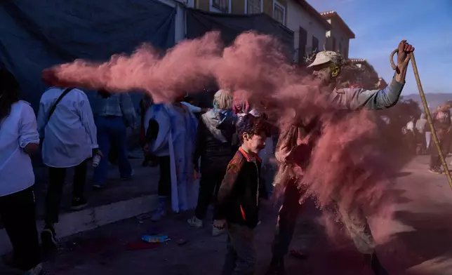 Revelers take part in the annual flour war marking the end of the Carnival season on Clean Monday in Galaxidi, about 200 kilometers (120 miles) west of Athens, Feb. 23, 2026, starting the 40-day Christian Lent fast leading to Easter. (AP Photo/Petros Giannakouris)