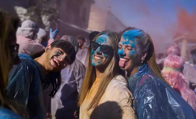 Revelers take part in the annual flour war marking the end of the Carnival season on Clean Monday in Galaxidi, about 200 kilometers (120 miles) west of Athens, Feb. 23, 2026, starting the 40-day Christian Lent fast leading to Easter. (AP Photo/Petros Giannakouris)