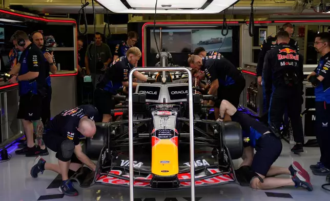 Mechanics of Red Bull driver Max Verstappen of the Netherlands prepare his car during a Formula One pre-season test at the Bahrain International Circuit in Sakhir, Bahrain, Wednesday, Feb. 11, 2026. (AP Photo/Altaf Qadri)