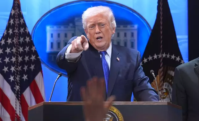 President Donald Trump points to a reporter during a press briefing at the White House, Friday, Feb. 20, 2026, in Washington. (AP Photo/Evan Vucci)