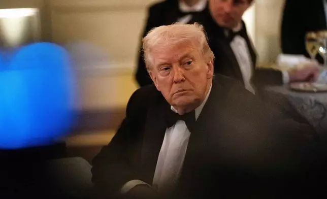 President Donald Trump attends the National Governors Association dinner at the White House, Saturday, Feb. 21, 2026, in Washington. (AP Photo/Allison Robbert)