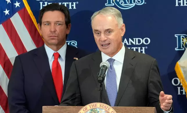 Major League Baseball commissioner Rob Manfred, right, speaks during a new baseball stadium news conference as Florida Gov. Ron DeSantis looks, Tuesday, Feb. 3, 2026, at Hillsborough College in Tampa, Fla. (AP Photo/Chris O'Meara)