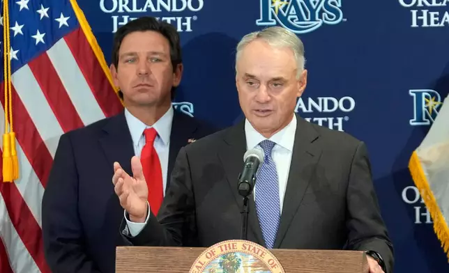 Major League Baseball commissioner Rob Manfred, right, gestures during a new baseball stadium news conference as Florida Gov. Ron DeSantis looks, Tuesday, Feb. 3, 2026, at Hillsborough College in Tampa, Fla. (AP Photo/Chris O'Meara)