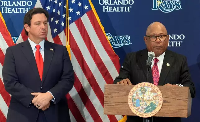 Hillsborough College president Dr. Ken Atwater, right, speaks during a new baseball stadium news conference as Florida Gov. Ron DeSantis looks on at Hillsborough College, Tuesday, Feb. 3, 2026, in Tampa, Fla. (AP Photo/Chris O'Meara)