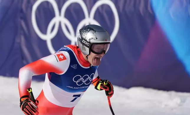 Switzerland's Marco Odermatt celebrates at the finish area of an alpine ski men's downhill race, at the 2026 Winter Olympics, in Bormio, Italy, Saturday, Feb. 7, 2026. (AP Photo/Rebecca Blackwell)