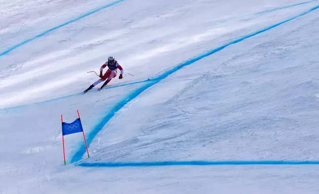 Switzerland's Marco Odermatt speeds down the course during an alpine ski, men's downhill race, at the 2026 Winter Olympics, in Bormio, Italy, Saturday, Feb. 7, 2026. (AP Photo/John Locher)