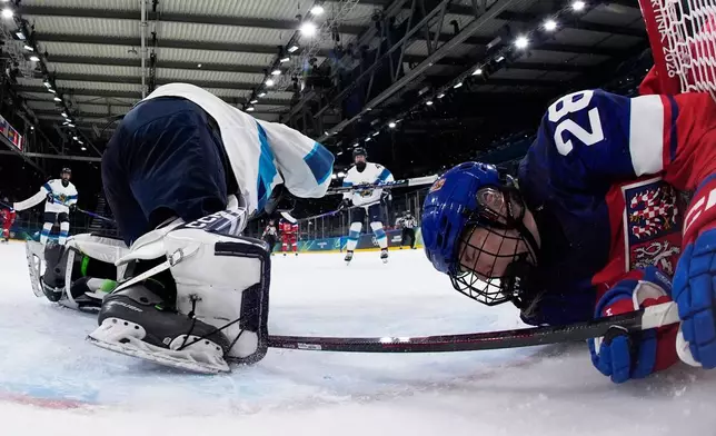 Czechia's Noemi Neubauerova crashes into the goal frame during a preliminary round match of women's ice hockey between Czechia and Finland at the 2026 Winter Olympics, in Milan, Italy, Sunday, Feb. 8, 2026. (AP Photo/Darko Bandic, Pool)