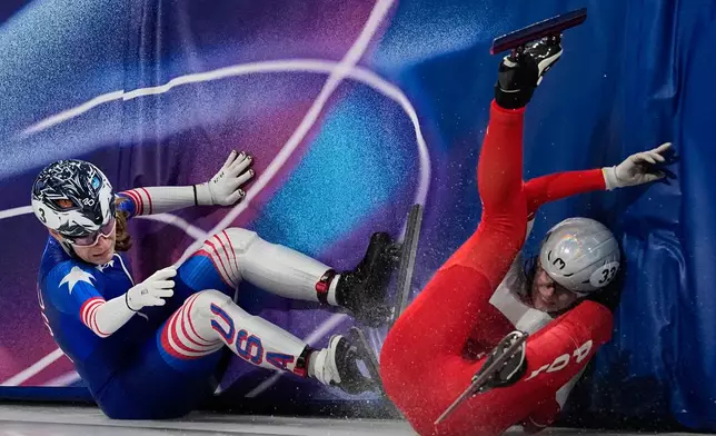 Corinne Stoddard of the United States crashes into Gabriela Topolska of Poland in the quarterfinals of the women's 1000 meter short track speed skating at the 2026 Winter Olympics, in Milan, Italy, Saturday, Feb. 14, 2026. (AP Photo/Ashley Landis)