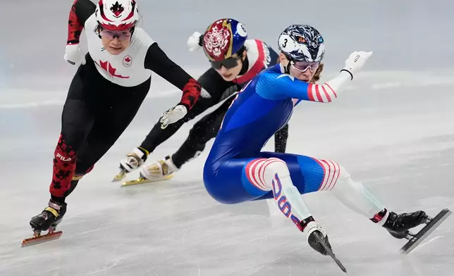 Corinne Stoddard, right, of the United States crashes as Courtney Sarault of Canada avoids her while competing in the team mixed relay short track speed skating at the 2026 Winter Olympics, in Milan, Italy, Tuesday, Feb. 10, 2026. (AP Photo/Ashley Landis)