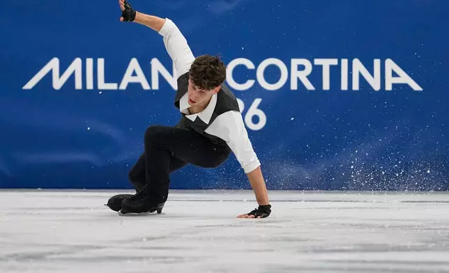 Lukas Britschgi of Switzerland falls during the men's figure skating short program at the 2026 Winter Olympics, in Milan, Italy, Tuesday, Feb. 10, 2026. (AP Photo/Ashley Landis)