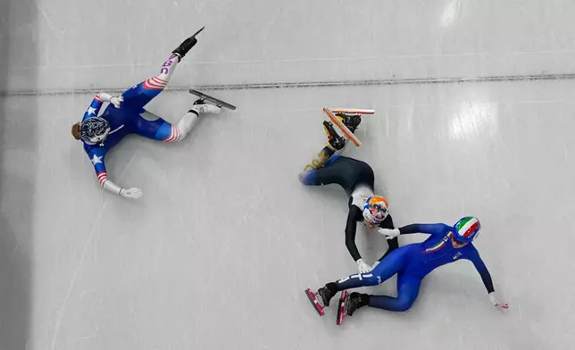 Italy's Arianna Sighel, right, United States' Corinne Stoddard, left, and Japan's Rika Kanai fall as they compete during the women's 500 meters short track speed skating heats race at the 2026 Winter Olympics, in Milan, Italy, Tuesday, Feb. 10, 2026. (AP Photo/Christophe Ena)