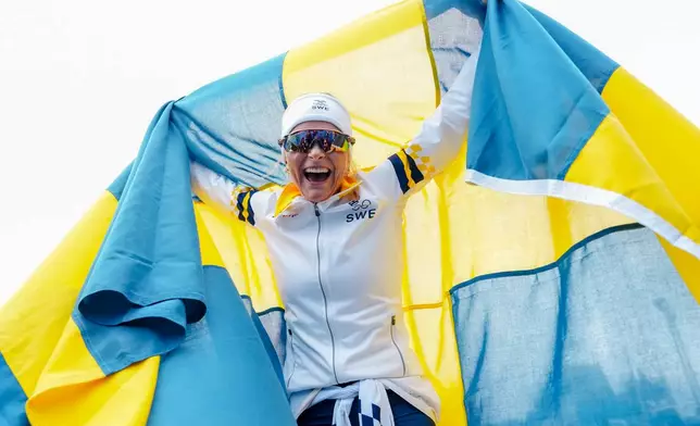 Frida Karlsson, of Sweden, celebrates after finishing the cross country skiing women's 10km interval start free at the 2026 Winter Olympics, in Tesero, Italy, Thursday, Feb. 12, 2026. (AP Photo/Kirsty Wigglesworth)