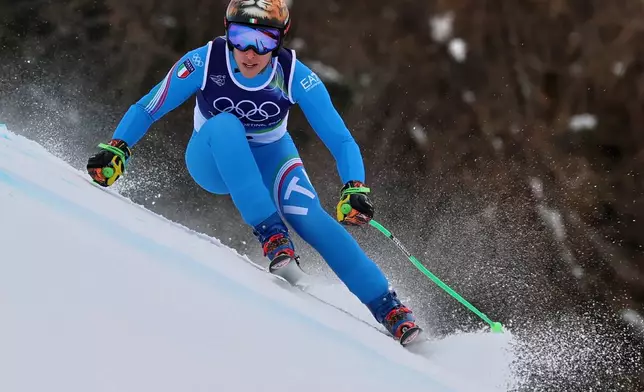 Italy's Federica Brignone speeds down the course, during an alpine ski, women's super-G race, at the 2026 Winter Olympics, in Cortina d'Ampezzo, Italy, Thursday, Feb. 12, 2026. (AP Photo/Marco Trovati)