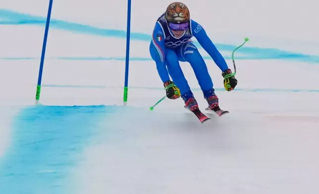 Italy's Federica Brignone speeds down the course during an alpine ski, women's super-G race, at the 2026 Winter Olympics, in Cortina d'Ampezzo, Italy, Thursday, Feb. 12, 2026. (AP Photo/Andy Wong)