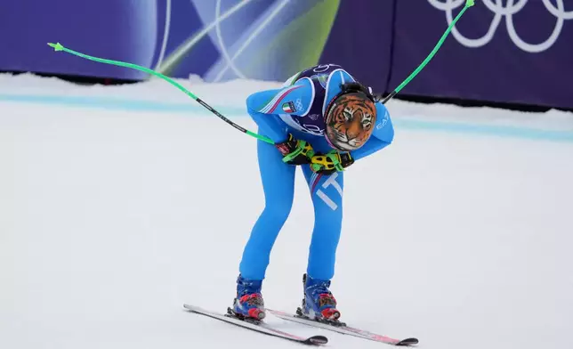 Italy's Federica Brignone celebrates at the finish area of an alpine ski, women's super-G race, at the 2026 Winter Olympics, in Cortina d'Ampezzo, Italy, Thursday, Feb. 12, 2026. (AP Photo/Jacquelyn Martin)