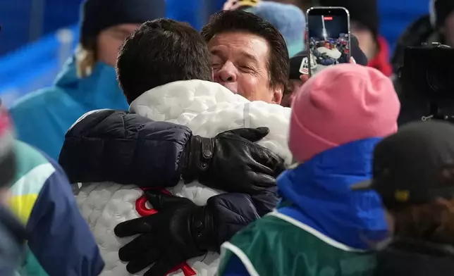 Gold medalist United States' Alex Ferreira, left, hugs his dad, Marcelo Ferreira, after winning the men's freestyle skiing halfpipe finals at the 2026 Winter Olympics, in Livigno, Italy, Friday, Feb. 20, 2026. (AP Photo/Lindsey Wasson)