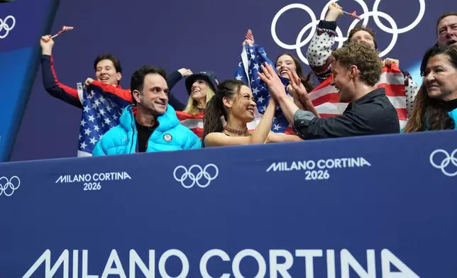 Madison Chock and Evan Bates of the United States react to their scores after competing during the figure skating ice dance team event at the 2026 Winter Olympics, in Milan, Italy, Friday, Feb. 6, 2026. (AP Photo/Stephanie Scarbrough)