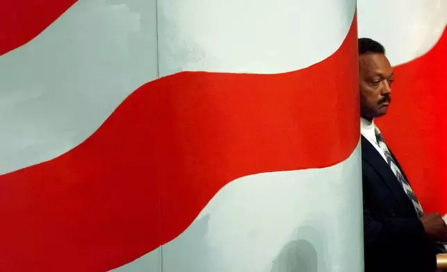 FILE - The Rev. Jesse Jackson waits while son Jesse Jackson Jr., introduces him to delegates at the United Center Tuesday, Aug. 27, 1996, in Chicago during the Democratic National Convention. (AP Photo/Ron Edmonds, File)