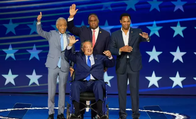 FILE - Rev. Jesse Jackson, center, waves to supporters as he is introduced during the Democratic National Convention, Aug. 19, 2024, in Chicago. With him on stage are Al Sharpton, Jonathan Jackson and Yusef DuBois Jackson. (AP Photo/J. Scott Applewhite, File)