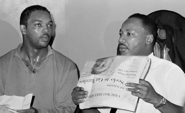 FILE - Civil rights leader Dr. Martin Luther King, Jr., right, and his aide Rev. Jesse Jackson are seen in Chicago, Aug. 19, 1966. (AP Photo/Larry Stoddard, File)