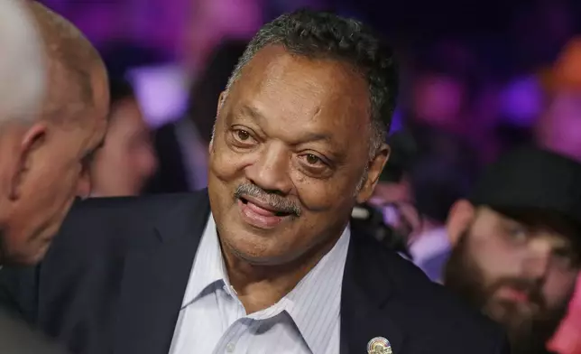 FILE - Jesse Jackson joins the crowd before the start of the world welterweight championship bout between Floyd Mayweather Jr., and Manny Pacquiao in Las Vegas on May 2, 2015. (AP Photo/Isaac Brekken, File)