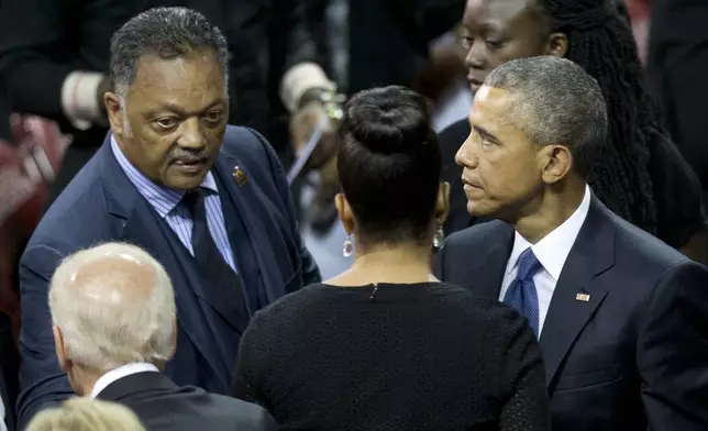 FILE - From left, Vice President Joe Biden, Rev. Jesse Jackson, first lady Michelle Obama, and President Barack Obama gather after services honoring the life of Reverend Clementa Pinckney at the College of Charleston TD Arena in Charleston, S.C., on June 26, 2015. (AP Photo/Carolyn Kaster, File)