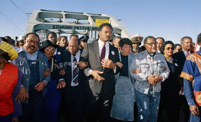 FILE - Civil rights figures lead marchers across the Edmund Pettus Bridge during the recreation of the 1965 Selma to Montgomery march in Selma, Ala., on March 4, 1990. From left are Hosea Williams, Georgia Congressman John Lewis, Rev. Jesse Jackson, Evelyn Lowery, SCLC President Joseph Lowery and Coretta Scott King. (AP Photo/Jamie Sturtevant, File)