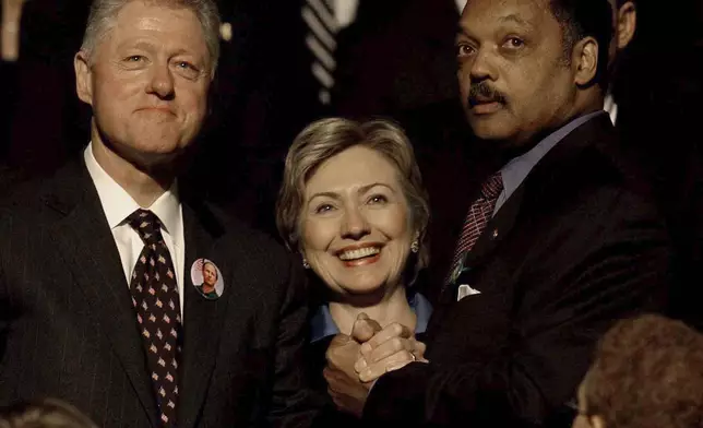 FILE - Former President Bill Clinton and his wife, U.S. Sen. Hillary Rodham Clinton, greet Jesse Jackson before a public memorial service, Oct. 29, 2002, in Minneapolis for U.S. Sen. Paul Wellstone, his wife, daughter and three staff members who died in a plane crash. (AP Photo/Stacy Wescott, Pool, File)