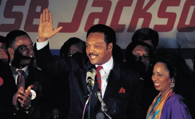 FILE - Jesse Jackson, with his wife Jacqueline, concedes defeat in the Illinois Democratic primary on March 16, 1988, in Chicago. (AP Photo/Lisa Genesen, File)