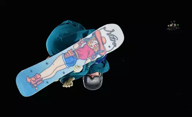 Finland's Eveliina Taka competes during the women's snowboard big air qualifications as a drone flies nearby at the 2026 Winter Olympics, in Livigno, Italy, Sunday, Feb. 8, 2026. (AP Photo/Gregory Bull)