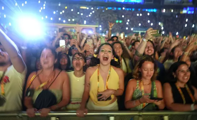 Fans cheer as Bad Bunny performs at the Allianz Parque stadium in Sao Paulo, Friday, Feb. 20, 2026. (AP Photo/Andre Penner)