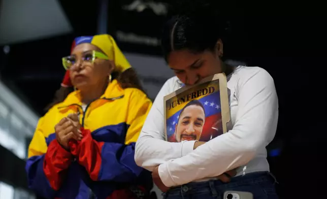 Relatives of detainees they say are held for political reasons wait outside El Helicoide, headquarters of Venezuela's intelligence service and a detention center, after the National Assembly approved an amnesty bill in Caracas, Venezuela, Thursday, Feb. 19, 2026. (AP Photo/Crisitian Hernandez)