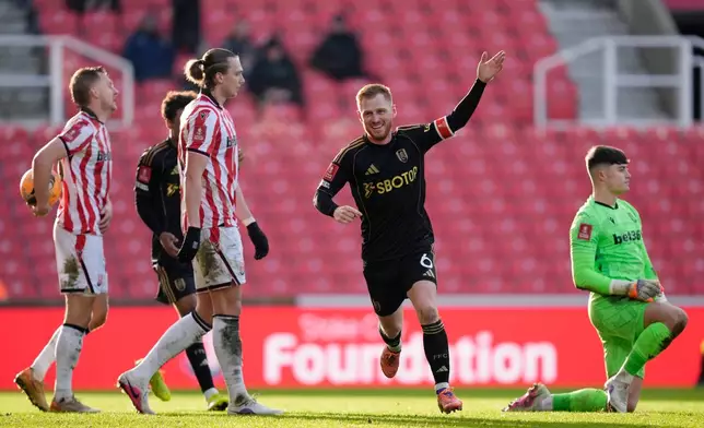Fulham's Harrison Reed celebrates after scoring his sides second goal during the English FA Cup fourth round match between Stoke City and Fulham, in Stoke, England, Sunday, Feb. 15, 2026. (Nick Potts/PA via AP)