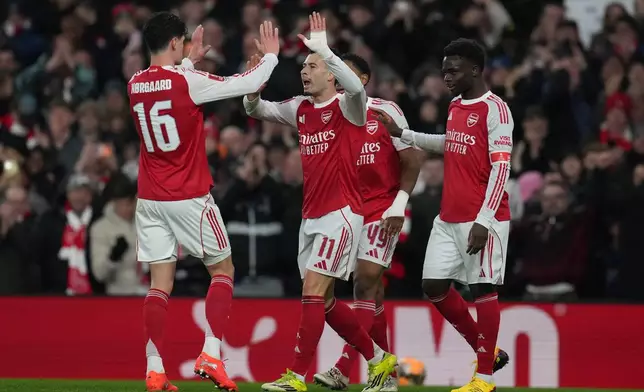Arsenal's Gabriel Martinelli, center, celebrates with teammates after scoring their side's second goal during the English FA Cup soccer match between Arsenal and Wigan Athletic in London, Sunday, Feb. 15, 2026.(AP Photo/Maja Smiejkowska)