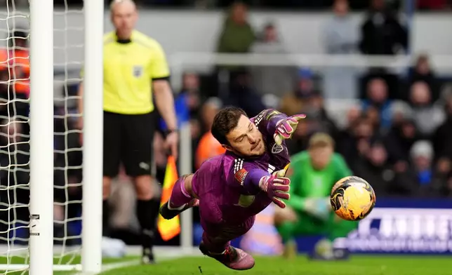 Leeds United goalkeeper Lucas Perri saves the penalty of Birmingham City's Tommy Doyle, not pictured, during the penalty shoot out at the end of the Emirates FA Cup fourth round match between Leeds United and Bimingham City, in Birmingham, England, Sunday Feb. 15, 2026. (Jacob King/PA via AP)