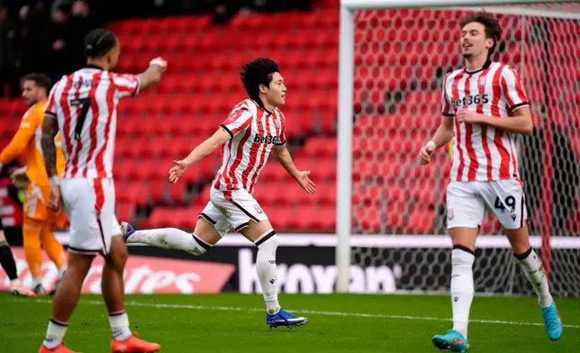 Stoke City's Bae Jun-Ho, centre, celebrates after scoring his side's first goal during the English FA Cup fourth round match between Stoke City and Fulham, in Stoke, England, Sunday, Feb. 15, 2026. (Nick Potts/PA via AP)