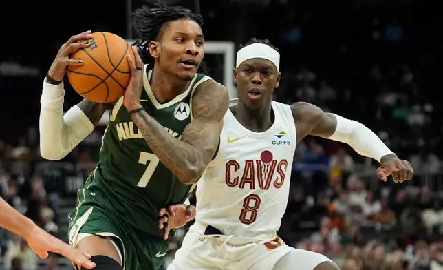 Milwaukee Bucks' Kevin Porter Jr. (7) drives to the basket against Cleveland Cavaliers' Dennis Schröder during the second half of an NBA basketball game Wednesday, Feb. 25, 2026, in Milwaukee. (AP Photo/Aaron Gash)