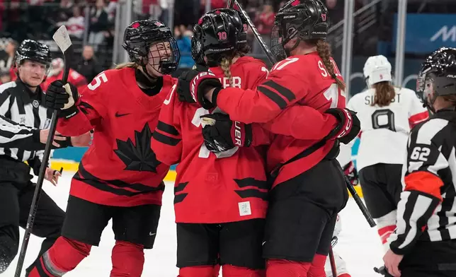 Canada players celebrate after Canada's Marie-Philip Poulin (29) scored her side's second goal during a women's ice hockey semifinal game between Canada and Switzerland at the 2026 Winter Olympics, in Milan, Italy, Monday, Feb. 16, 2026. (AP Photo/Hassan Ammar)
