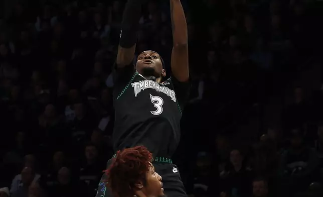 Minnesota Timberwolves forward Jaden McDaniels (3) shoots over Philadelphia 76ers guard Kelly Oubre Jr. (9) during the first half of an NBA basketball game Sunday, Feb. 22, 2026, in Minneapolis. (AP Photo/Stacy Bengs)