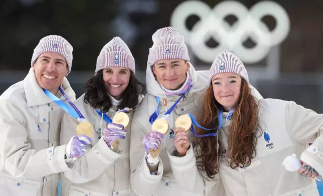 France's Julia Simon, Lou Jeanmonnot, Quentin Fillon Maillet and Eric Perrot pose with their gold medals in the 4X6-kilometer mixed relay biathlon race at the 2026 Winter Olympics in Anterselva, Italy, Sunday, Feb. 8, 2026. (AP Photo/Andrew Medichini)
